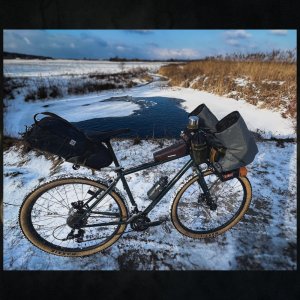 winter bikepacking gravel bike warm gloves pogies river icy snow
